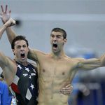 Michael Phelps, right, and teammate Garret Weber-Gale cheer at their team's win.